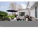 Backyard patio with string lights, patio umbrella, fire pit, grill, and stylish outdoor seating at 2428 Hawthorn Pl, Noblesville, IN 46062