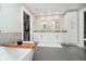 Bright bathroom with double vanity, storage cabinets, grey tile floor, and walk-in closet at 2428 Hawthorn Pl, Noblesville, IN 46062