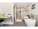 Well-lit bathroom featuring a soaking tub, glass shower, and vanity area at 2428 Hawthorn Pl, Noblesville, IN 46062