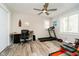 Versatile bedroom with a ceiling fan, laminate floor, desk, and exercise equipment at 2428 Hawthorn Pl, Noblesville, IN 46062