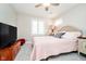 Cozy bedroom with a soft pink color scheme, large window, and comfortable furnishings at 2428 Hawthorn Pl, Noblesville, IN 46062