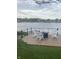 Relaxing deck space with lakeside views and cozy seating around a modern fire pit at 2428 Hawthorn Pl, Noblesville, IN 46062