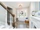 Inviting foyer featuring beautiful flooring, a staircase, and a decorative wreath on the front door at 2428 Hawthorn Pl, Noblesville, IN 46062