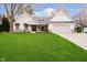 Charming home with a lush front yard, light stone accents, and a welcoming entrance at 2428 Hawthorn Pl, Noblesville, IN 46062