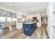 Open concept kitchen with a large island, white cabinets, and stainless steel appliances at 2428 Hawthorn Pl, Noblesville, IN 46062