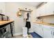 Well-organized laundry room with storage, sink, modern washer and dryer and a 