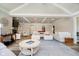 Spacious living room with white couches, overhead lighting, and a neutral color palette at 2428 Hawthorn Pl, Noblesville, IN 46062
