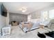 Comfortable main bedroom with a light blue color scheme, large bed, and accent seating at 2428 Hawthorn Pl, Noblesville, IN 46062