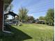 View of the backyard featuring a large lawn, gazebo, and shed in a suburban neighborhood at 244 E Cragmont Dr, Indianapolis, IN 46227
