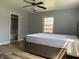 This bedroom has a ceiling fan and wood-look flooring at 244 E Cragmont Dr, Indianapolis, IN 46227