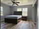 This bedroom has a ceiling fan and wood-look flooring at 244 E Cragmont Dr, Indianapolis, IN 46227