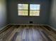 Simple bedroom features new floor and a window allowing natural light at 244 E Cragmont Dr, Indianapolis, IN 46227