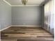 Bright dining room with new floors, a modern chandelier, and large windows at 244 E Cragmont Dr, Indianapolis, IN 46227