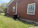 Side view of a brick house with well-maintained lawn and visible air conditioning unit at 244 E Cragmont Dr, Indianapolis, IN 46227