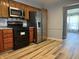 Modern kitchen featuring stainless steel appliances and wood-style flooring at 244 E Cragmont Dr, Indianapolis, IN 46227