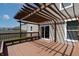 Back deck with brown pergola, bench seating, and sliding glass door at 2545 Coneflower Ct, Columbus, IN 47201