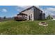 A spacious backyard features a deck with pergola and a stone fire pit, creating a relaxing outdoor space at 2545 Coneflower Ct, Columbus, IN 47201