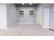 Finished basement area featuring floating shelves, neutral paint and plush carpeting at 2545 Coneflower Ct, Columbus, IN 47201