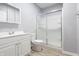 Bathroom with white vanity, toilet and shower featuring sliding glass doors at 2545 Coneflower Ct, Columbus, IN 47201