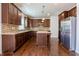 A stylish kitchen features dark wood cabinetry, stainless steel appliances, granite counters and tile backsplash at 2545 Coneflower Ct, Columbus, IN 47201