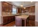 This spacious kitchen offers lots of wood cabinets, stone countertops, stainless appliances and a center island at 2545 Coneflower Ct, Columbus, IN 47201