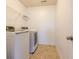 Well-lit laundry room with side-by-side washer and dryer and tile flooring at 2545 Coneflower Ct, Columbus, IN 47201
