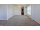Spacious living room with neutral carpet, bright natural light, and view into the kitchen at 2545 Coneflower Ct, Columbus, IN 47201