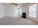 A bright living room with carpet flooring and a fireplace adds cozy warmth at 2545 Coneflower Ct, Columbus, IN 47201
