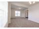 Spacious living room with neutral carpet and bright natural light, and view into the entryway at 2545 Coneflower Ct, Columbus, IN 47201