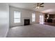 A bright living room with carpet flooring and a fireplace is adjacent to the kitchen at 2545 Coneflower Ct, Columbus, IN 47201