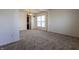Spacious living room with neutral carpet, bright natural light, and view into the dining area at 2545 Coneflower Ct, Columbus, IN 47201