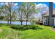Beautiful lake view from the backyard featuring mature trees and patio at 2809 Somerset Bay, Indianapolis, IN 46240