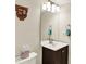 Bathroom featuring a dark wood vanity with a white sink and a large mirror at 2809 Somerset Bay, Indianapolis, IN 46240