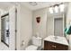 Bathroom with toilet and vanity with chrome hardware and a large mirror at 2809 Somerset Bay, Indianapolis, IN 46240