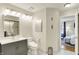Well-lit bathroom with vanity, marble floors, and adjacent bedroom at 2809 Somerset Bay, Indianapolis, IN 46240