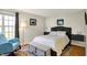 Comfortable bedroom with natural light, warm wood floors, soft blue rocking chair, and cozy decor at 2809 Somerset Bay, Indianapolis, IN 46240