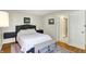 Comfortable bedroom featuring wood floors, neutral walls, and a decorative storage trunk at the foot of the bed at 2809 Somerset Bay, Indianapolis, IN 46240