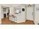 The condo's entrance with barstool seating has a modern light fixture and gleaming hardwood floors at 2809 Somerset Bay, Indianapolis, IN 46240