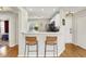 The condo entrance overlooks the kitchen featuring modern barstools and hardwood floors throughout at 2809 Somerset Bay, Indianapolis, IN 46240