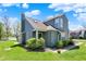 Inviting two-story condo with lush greenery, a chimney, and a serene view of the lake at 2809 Somerset Bay, Indianapolis, IN 46240