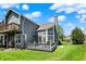 Exterior view of the home featuring a backyard deck and well-maintained lawn with mature trees at 2809 Somerset Bay, Indianapolis, IN 46240