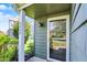Inviting entrance to a condo featuring a glass front door, decorative light and green surroundings at 2809 Somerset Bay, Indianapolis, IN 46240