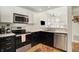 Well-equipped kitchen featuring modern appliances, granite counters, hardwood floors and ample light at 2809 Somerset Bay, Indianapolis, IN 46240