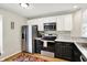 Well-lit kitchen featuring stainless steel appliances, tile backsplash and modern fixtures at 2809 Somerset Bay, Indianapolis, IN 46240