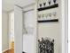 Stacked washer and dryer in a laundry area with decorative shelves and glassware at 2809 Somerset Bay, Indianapolis, IN 46240