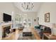 Bright living room with fireplace, hardwood floors, and vaulted ceiling, creating an airy space at 2809 Somerset Bay, Indianapolis, IN 46240