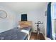 Bright bedroom with wood-look floors, cozy furniture, and a large window at 2822 Walker Ave, Indianapolis, IN 46203