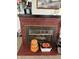 Close-up of a brick fireplace with seasonal decorations and assorted household objects nearby at 3333 S Sr 9, Greenfield, IN 46140