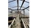 Inside a greenhouse, featuring raised wooden platforms perfect for plant cultivation at 3333 S Sr 9, Greenfield, IN 46140