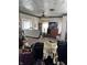 Untidy living room with outdated decor, including a ceiling fan, and various household items at 3333 S Sr 9, Greenfield, IN 46140